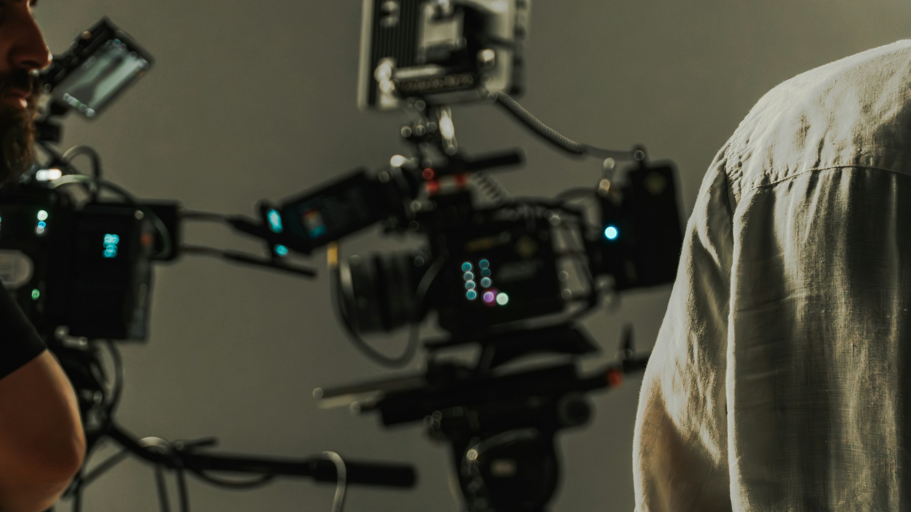 Professional cameras and crew working on a studio set